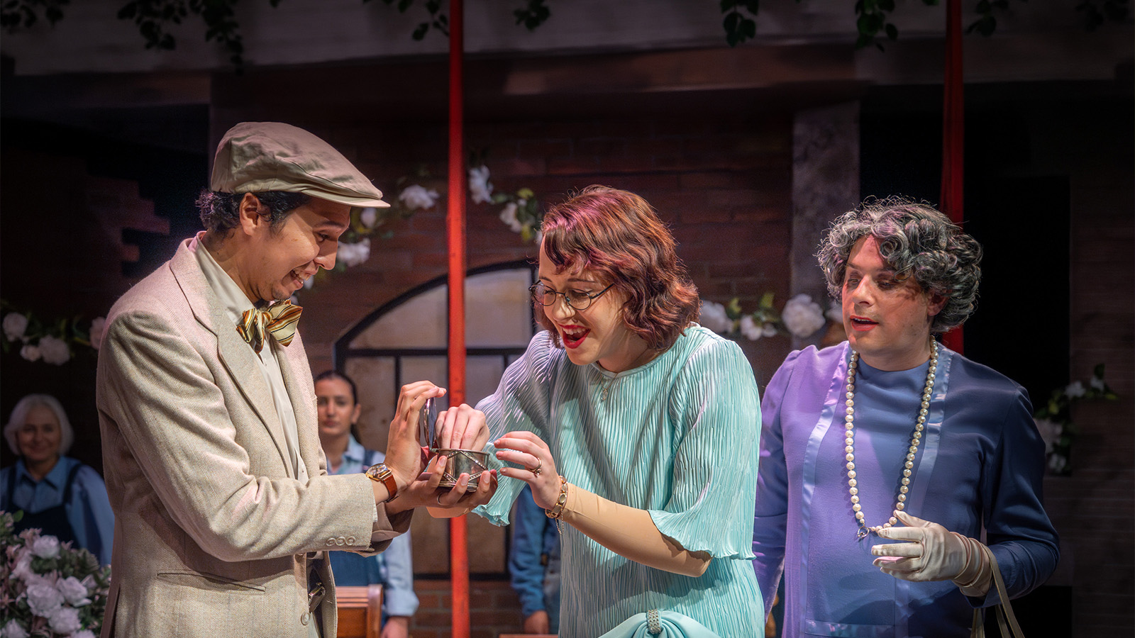 Students performing a live theatre scene on stage.